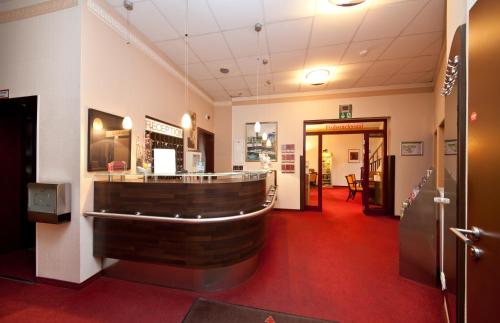 a large room with a bar in the middle of a building at Hotel Polo am ZOB in Hamburg