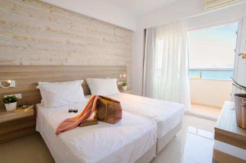 a bedroom with a large bed with a large window at Orpheus Studios in Kos Town