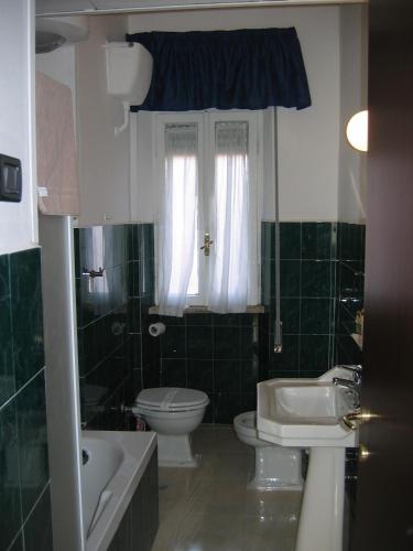a bathroom with a toilet and a sink at Hotel Antico Acquedotto in Rome
