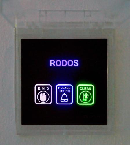 a clock with neon signs on a wall at 12 Islands Villas in Kolimbia