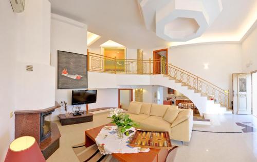 a living room with a couch and a staircase at 12 Islands Villas in Kolimbia