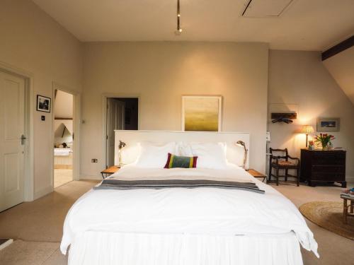 a bedroom with a large white bed in a room at The Clock Tower in Daventry