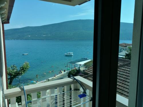 a view of a beach from a balcony at Vila Jadranka Apartments in Herceg-Novi