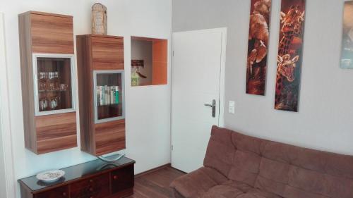 a living room with a couch and a book shelf at FeWos im alten Bahnhof in Lauterecken