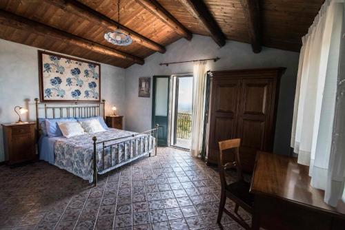 a bedroom with a bed and a large window at Seacily Etna House in Piedimonte Etneo