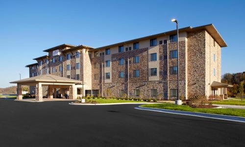 a large building with a road in front of it at Hawthorn Suites by Wyndham Wheeling at The Highlands in Triadelphia