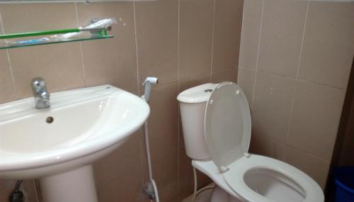 a bathroom with a toilet and a sink at Praasad Paradise in Cox's Bazar