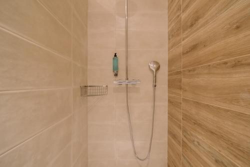 a shower with a shower head in a bathroom at Quinta dos Poetas Nature Hotel & Apartments in Olhão