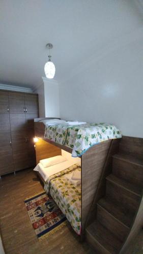 a room with a bunk bed and a staircase at Villa Royal House in Makhinjauri