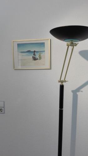 a lamp and a picture on a wall with a picture at FeWos im alten Bahnhof in Lauterecken
