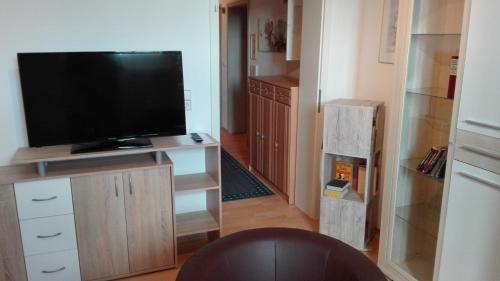 a living room with a flat screen tv on a entertainment center at FeWos im alten Bahnhof in Lauterecken