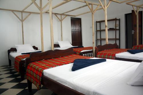 Katil atau katil-katil dalam bilik di Kimte Beach Lodge
