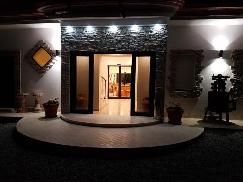 a large room with a round room with a stone wall at Hotel La Campagnola in Capo Vaticano