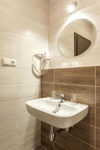 a bathroom with a sink and a mirror at Old Town Trio in Vilnius