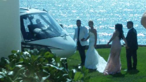 a group of people standing in front of a helicopter at La Mansión Residency Suites Ensenada in Ensenada
