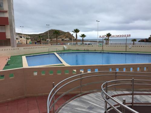 a swimming pool in a building next to a building at La Isla in Puerto de Mazarrón