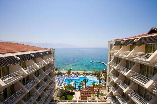 a view of the ocean from between two buildings at Fantasia Deluxe Hotel in Kuşadası