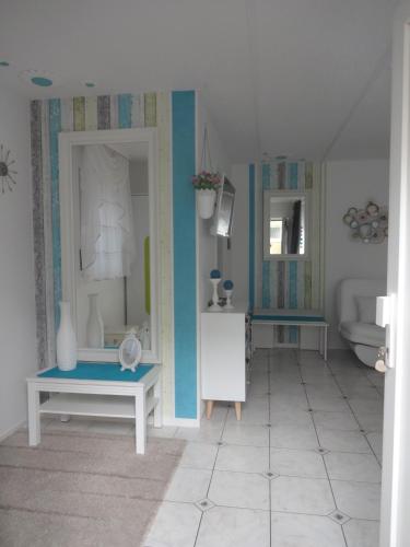 a bathroom with blue walls and a white tile floor at Ferienwohnung Kessler in Rust