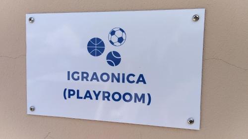 a sign on a wall with a soccer ball at Apartments Dania in Lopar