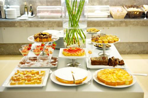 a table with many different types of food on it at Mercure Palermo Centro in Palermo