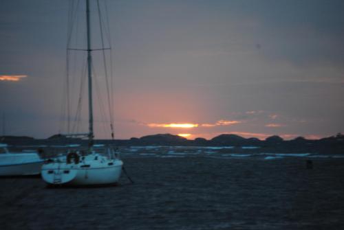 a boat on the beach with the sunset in the background at Fajardo Peaceful Place in Playa Sardinera