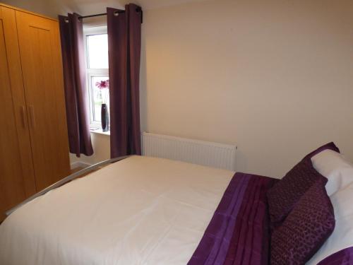 a bedroom with a bed and a window at Birdholme House in Chesterfield