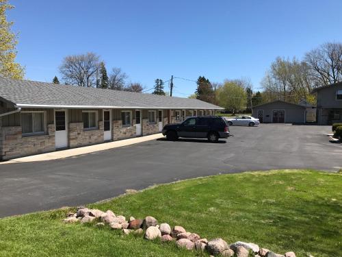 a car parked in a parking lot next to a building at Marinette Inn in Marinette