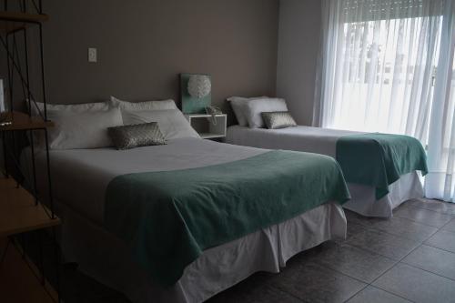 Una cama o camas en una habitación de Argenta Apart Hotel