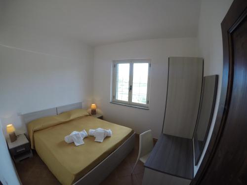 a small bedroom with a bed and a window at Residence Pantaleo in Ricadi