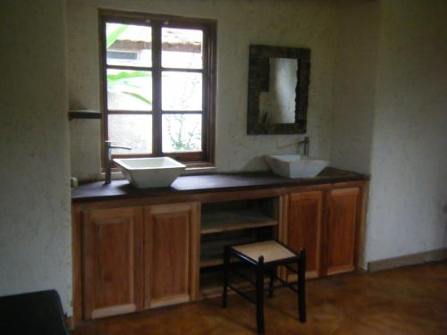 a bathroom with two sinks on a counter with a window at Lejartre's Retreat in Mount James