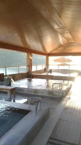 a large pool of water in a building at Dong Tair Spa Hotel in Wenquan