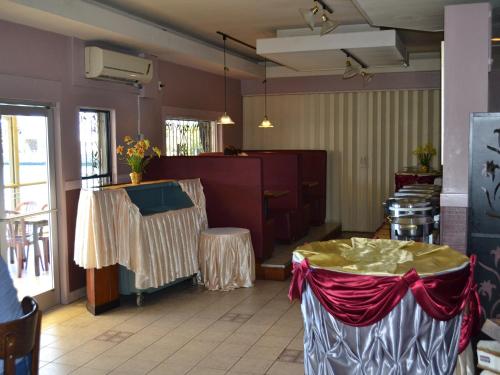 a dining room with a table and chairs and a table sidx sidx at West Plaza Malakal in Koror