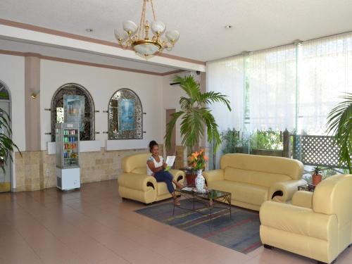 a woman sitting in a waiting room in a lobby at West Plaza Malakal in Koror