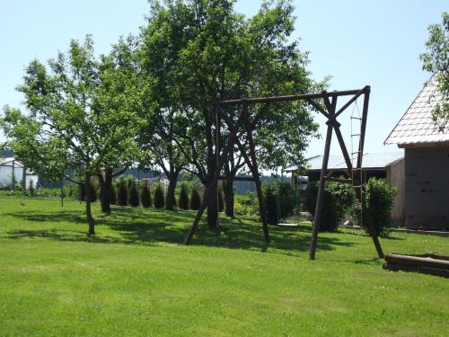 a swing set in the middle of a grass field at Penzion U Račáku in Frymburk