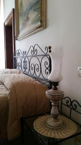 a bedroom with a bed and a table with a lamp at Pigiotto in Pesaro