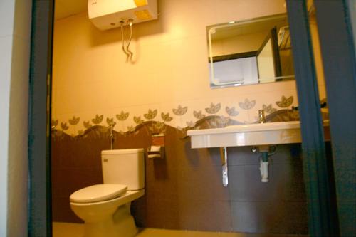 a bathroom with a toilet and a sink at Son Ha Hotel SAPA in Sapa