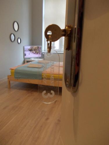 a bedroom with a bed with a laptop on it at FRESCO Suite & Rooms in Łódź