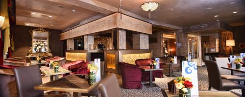 a restaurant with tables and chairs and a fireplace at Papadopoli Hotel Venezia - MGallery Collection in Venice