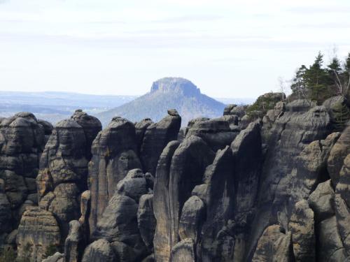 a rock formation with a mountain in the background at Ferienwohnung Büchsenhof in Prossen