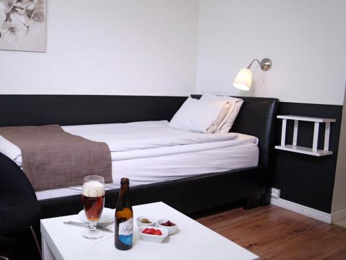 a room with a bed and a bottle of wine on a table at Best Western Gustaf Froding Hotel & Konferens in Karlstad