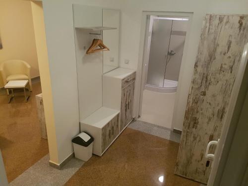 a bathroom with a shower and a sink and a toilet at Apartments O Sole Mio in Vukovar