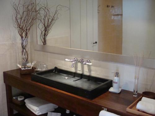 a bathroom with a black sink and a mirror at Hotel Trias in Palamós