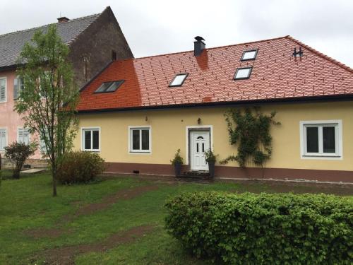 a yellow house with a red roof at Ferienwohnung Kickmaier in Bad Radkersburg