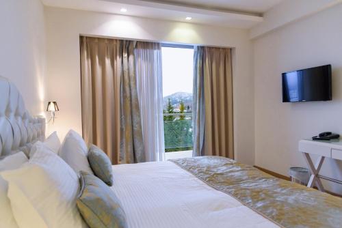 
Ένα ή περισσότερα κρεβάτια σε δωμάτιο στο Calma Hotel & Spa
