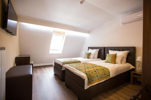 a bedroom with a bed and a window at Heartland City B&B in Tuzla