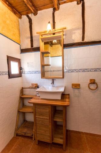 a bathroom with a sink and a mirror at El castanar in San Esteban de la Sierra