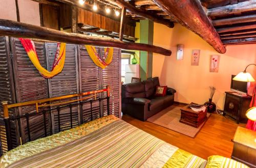 a living room with a couch and a room with at El castanar in San Esteban de la Sierra
