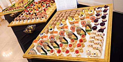 a display of desserts and pastries on a table at Pension Hanul Andritei in Craiova