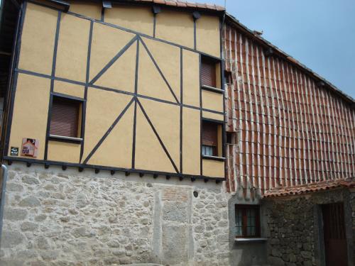 a large building with a tiled roof at El castanar in San Esteban de la Sierra