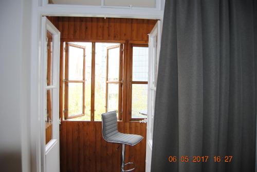 einem Stuhl vor einem Fenster in der Unterkunft Ruhige Ferienwohnung in der City Königswohnung in Kiel